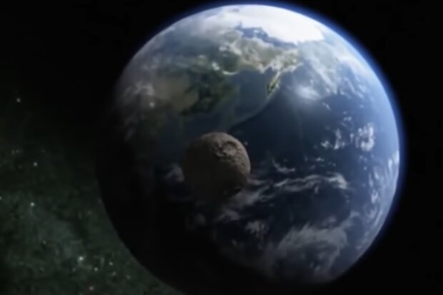Приближение астероида к планете Земля.  Фото: скриншот YouTube-видео